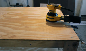 Sand plywood tops of the workbench